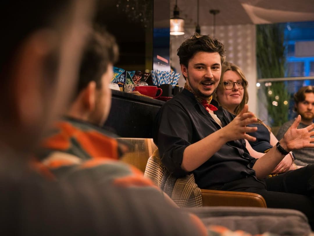 Dewi Johnson engaged in a conversation with members during a directing session