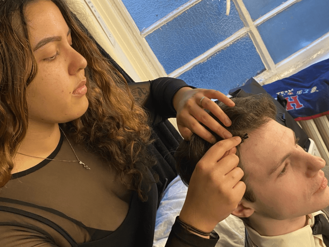 Liana, Sound Intern, fitting a radio mic to a cast member of Harry Potter and the Cursed Child.