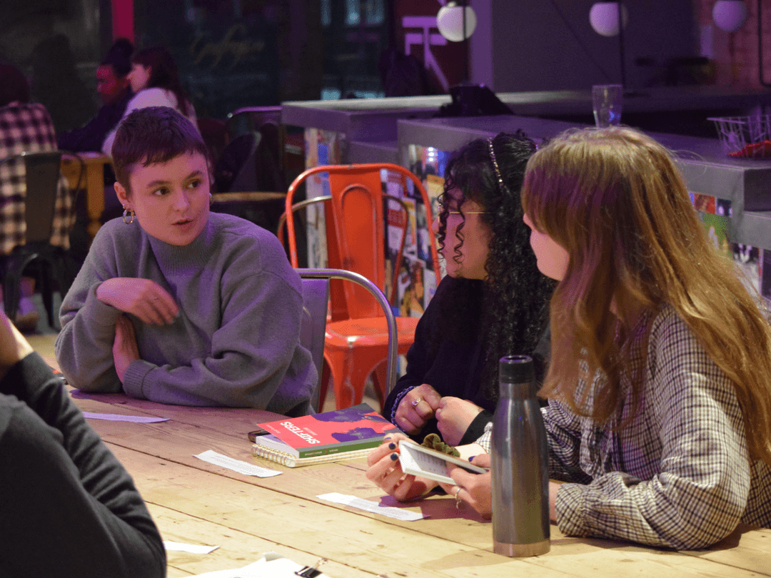 A small group of Masterclass members discussing Shifters by Benedict Lombe