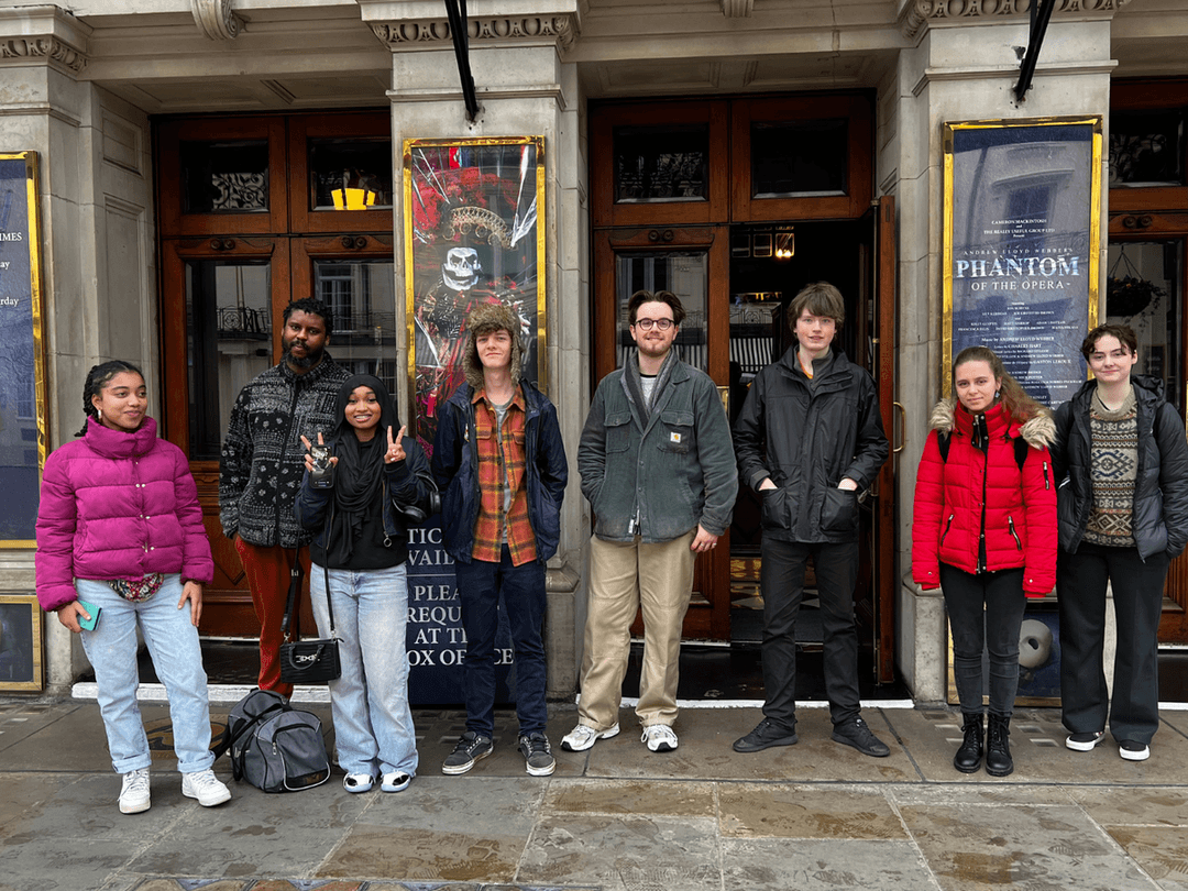 A group of young people from Avenues Youth Project and individuals stood outside of the Phantom of the Opera.
