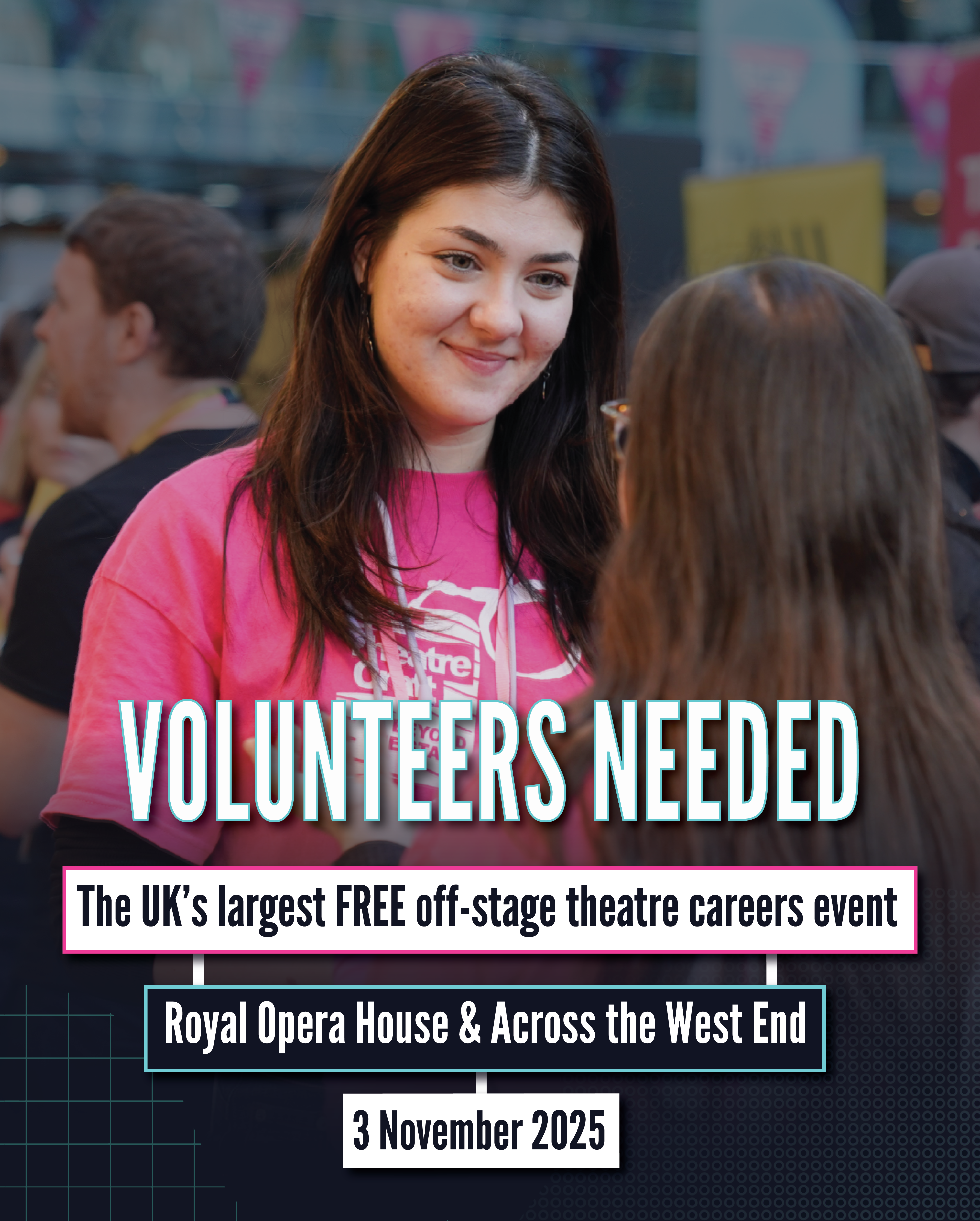 A smiley young woman in a bright pink TheatreCraft t-shirt faces another young person with their back to the camera.