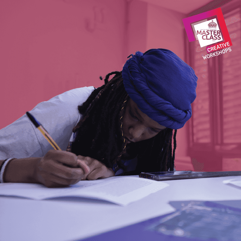 Photo of a young person writing on a script with a pen. 
