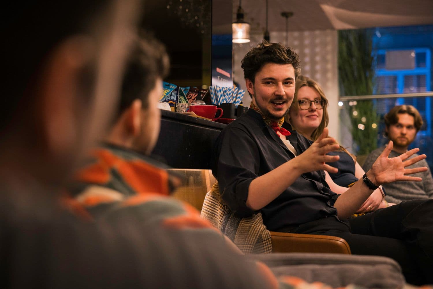 Dewi Johnson engaged in a conversation with members during a directing session