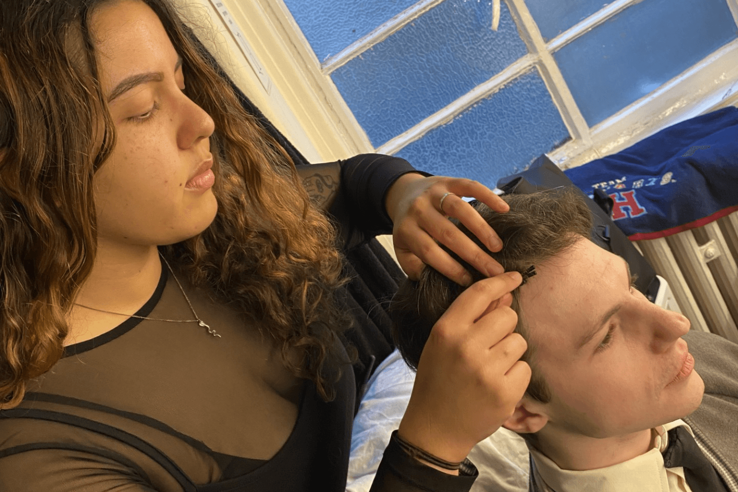 Liana, Sound Intern, fitting a radio mic to a cast member of Harry Potter and the Cursed Child.