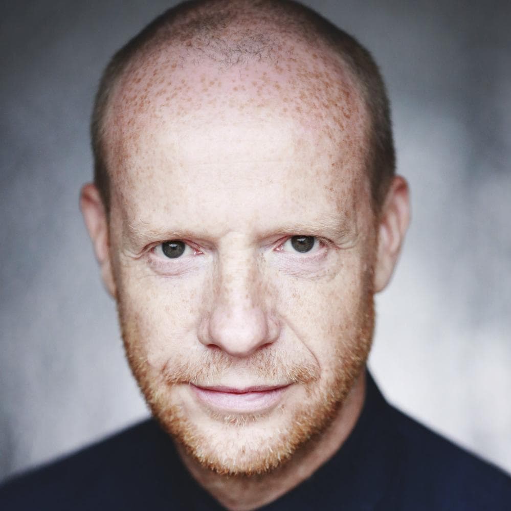 Jonathan Slinger Headshot, a white man with lots of freckles, brown eyes and a short gingery beard.