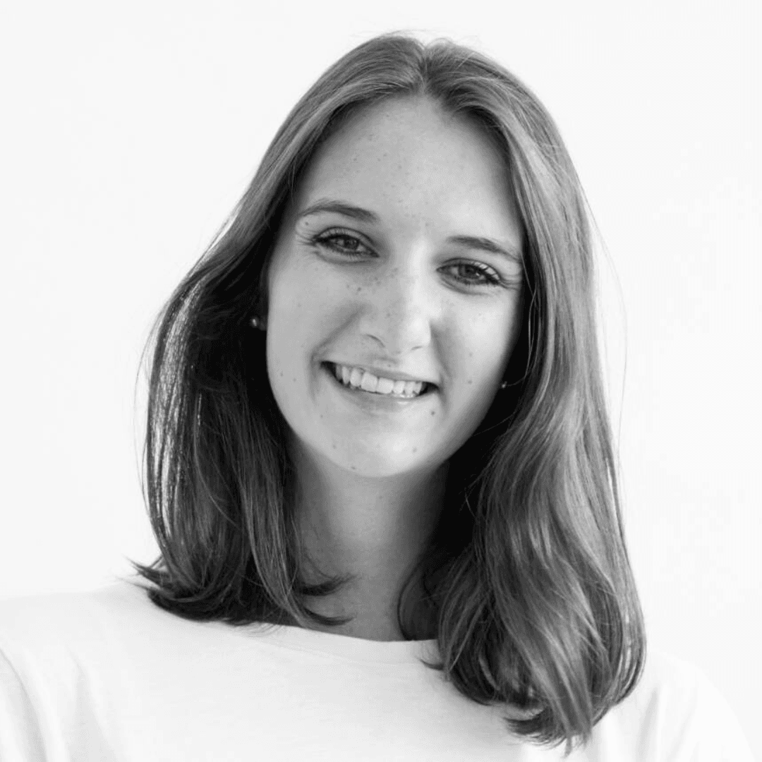 Headshot of Rebecca Gwyther. Black and white close-up portrait of a smiling young woman with medium-length hair, wearing a light-colored top against a plain background.