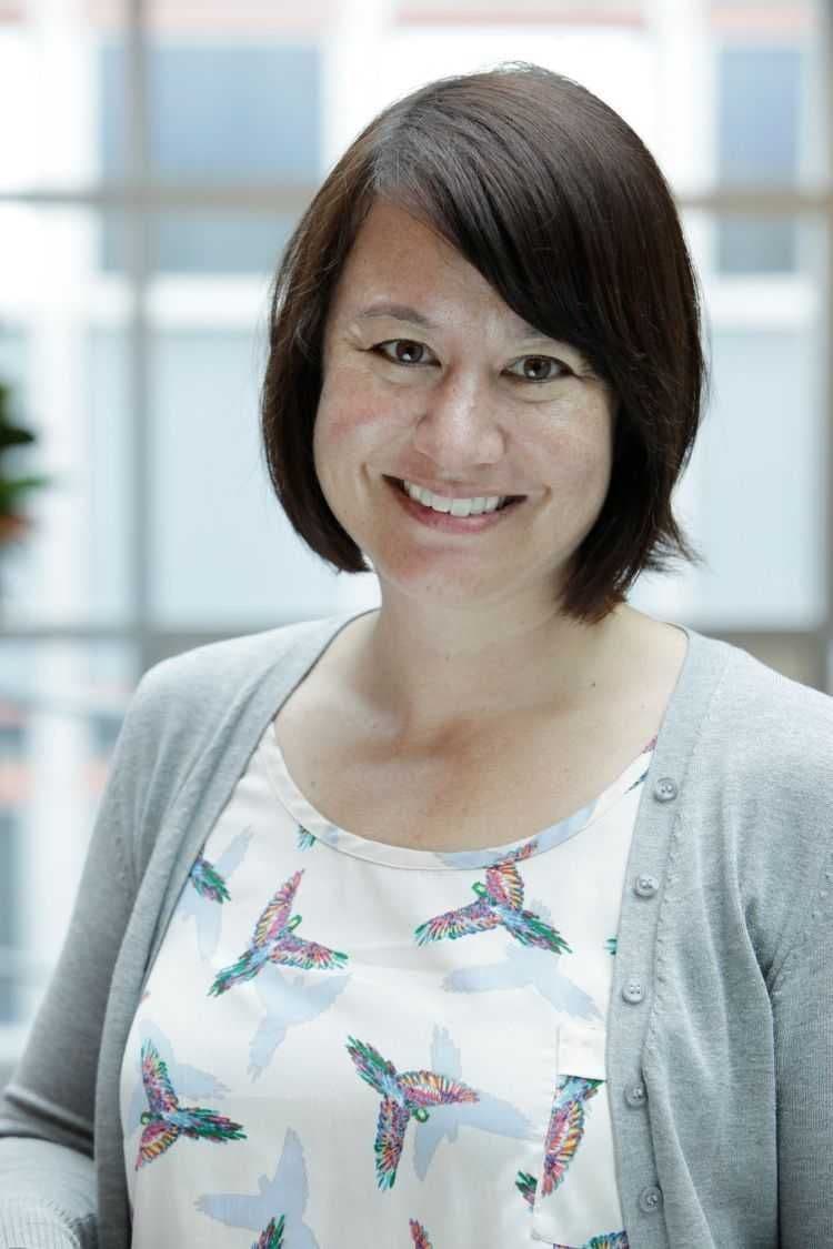 An Asian New Zealander with short black hair, with an open smile.
