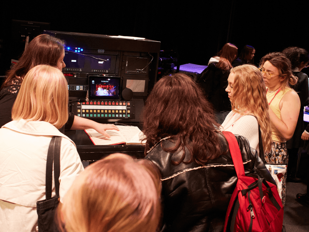 A group of young people gathered around at a stage management workshop at TheatreCraft